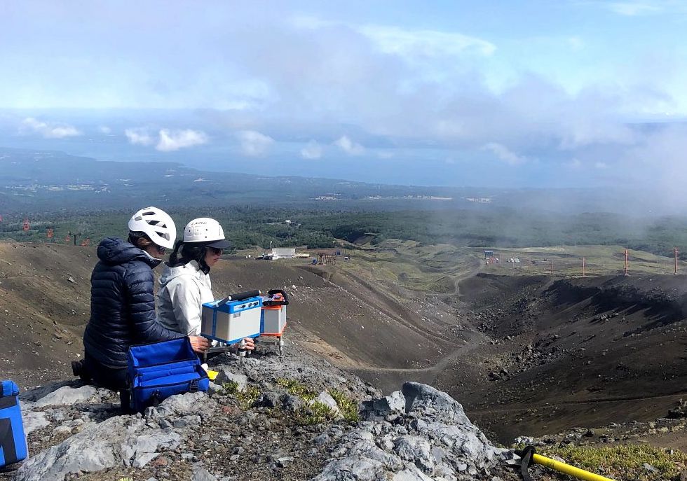 Helene le Mevel and Kathleen McKee setting up a gravimeter on Villarrica volcano in Chile as part of pioneering work to use gravity as a volcano monitoring tool