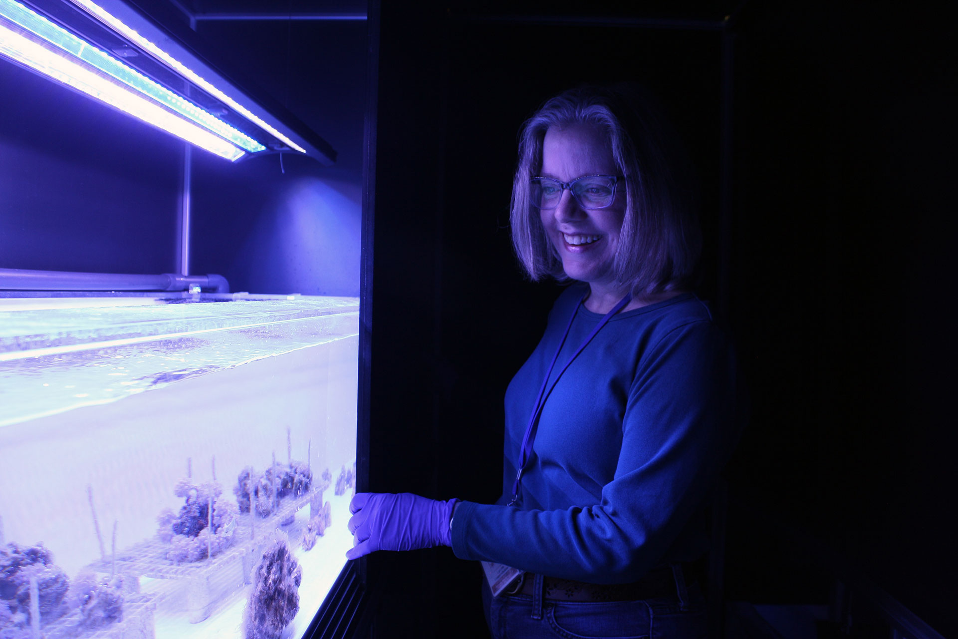 Lynne Hugendubler with a coral tank