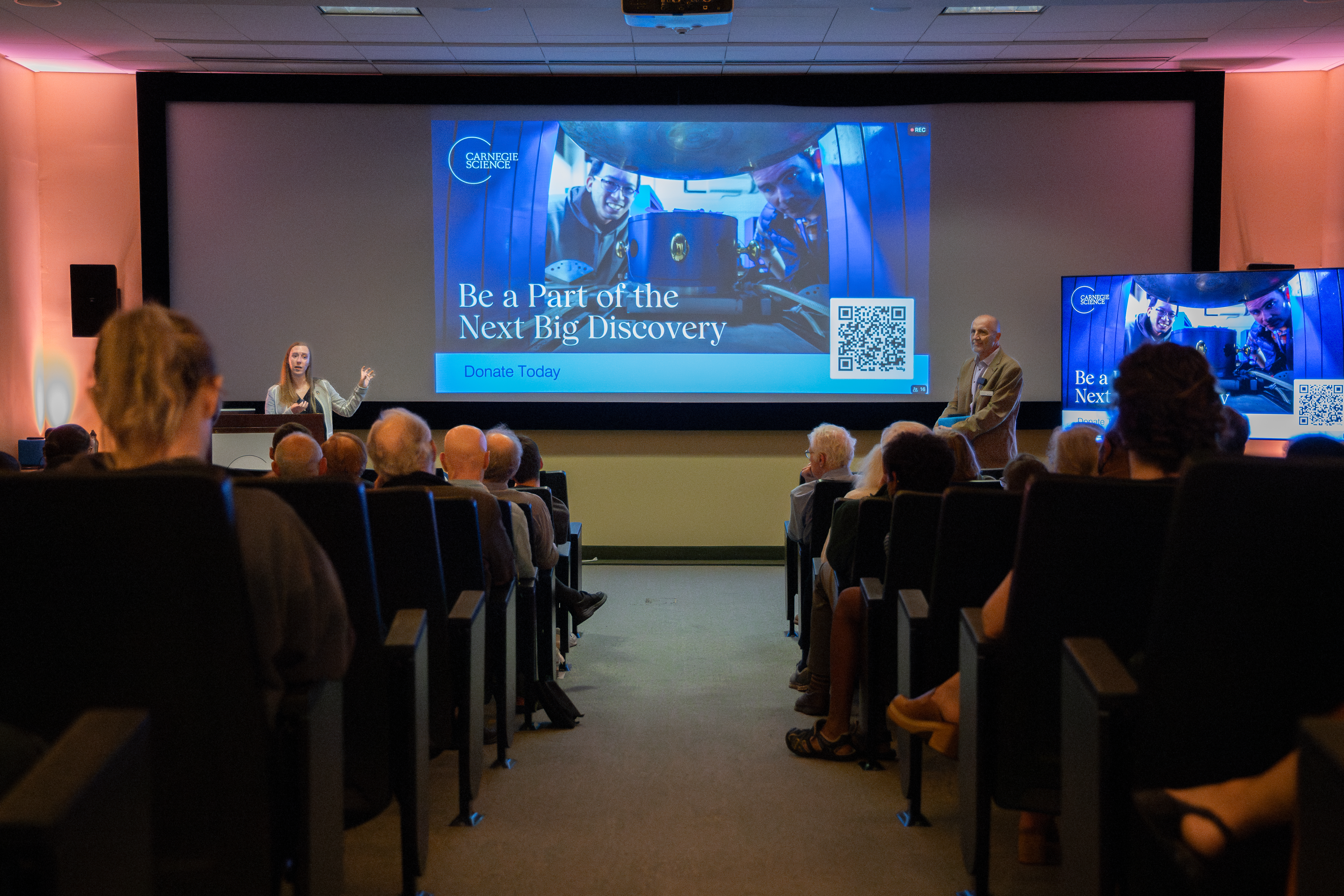 The crowd learns how to support Carnegie Science and postdoctoral research. 
