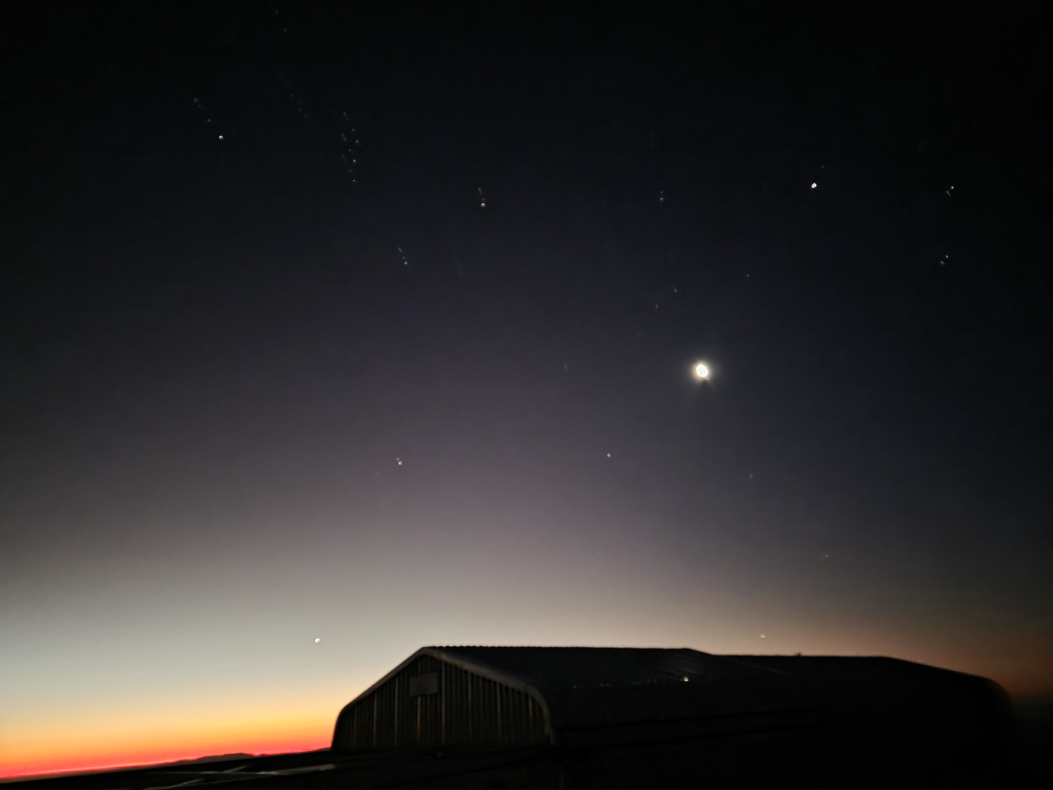 Two visble planets at sunset: Venus (near the horizon) and Jupiter ( to the right of the Moon)