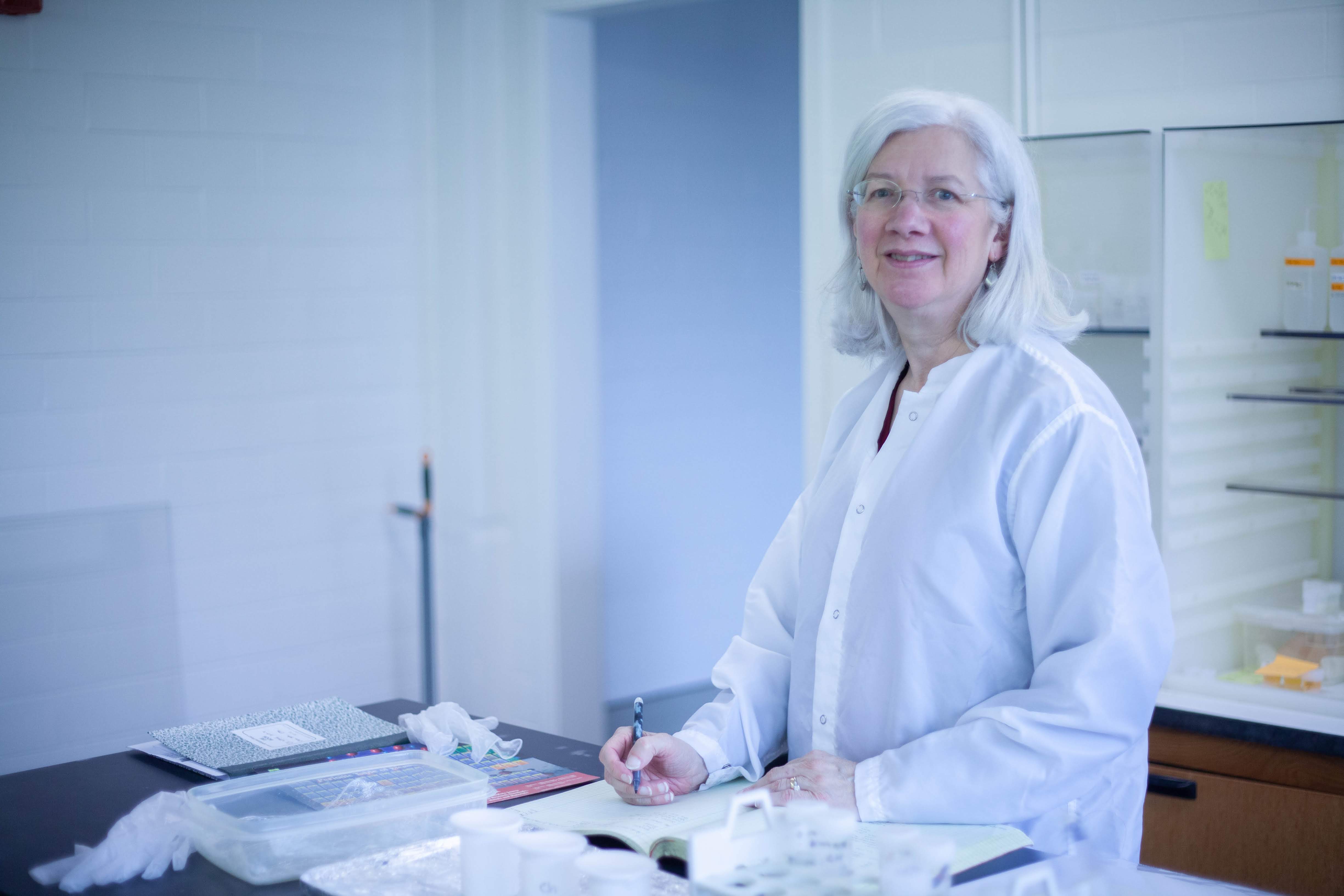 Mary Horan takes notes in her lab notebook as she runs the liquid chromatography of glacial deposit samples for her own research. Credit: Katy Cain