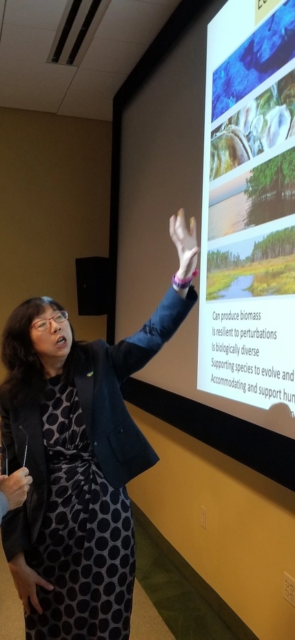 Dr Yixian Zheng Explains Biological Systems to Enthusiastic Neigbhors.jpeg