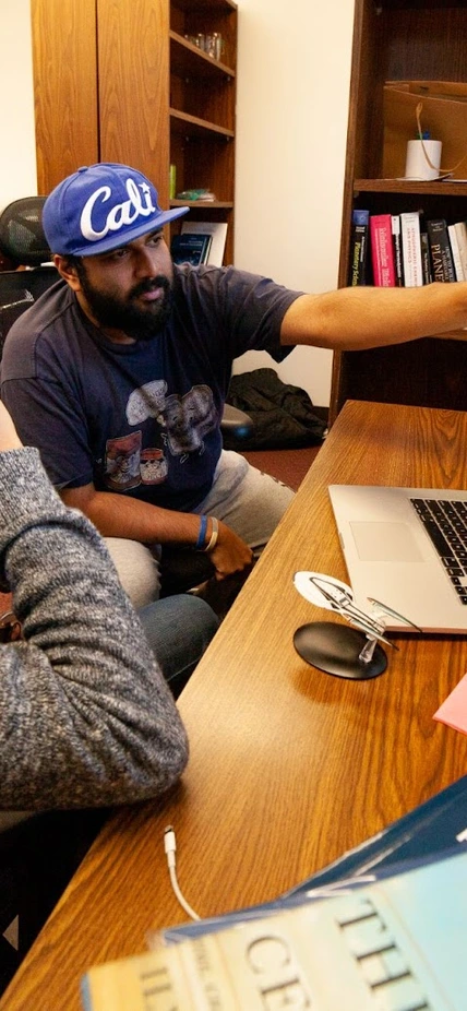 Mike Wong and colleague Anirudh Prabhu discuss how to tweak the presentation of a network of Earth's atmospheric chemistry in their shared office on the Broad Branch Road campus. 