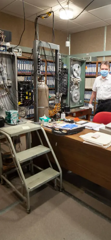 Steven Golden stands in the old-school tape storage archive which stores the historic collection of data from seismic broadband stations operated by Carnegie Science under Selwyn Sacks between 1965 and 2004.