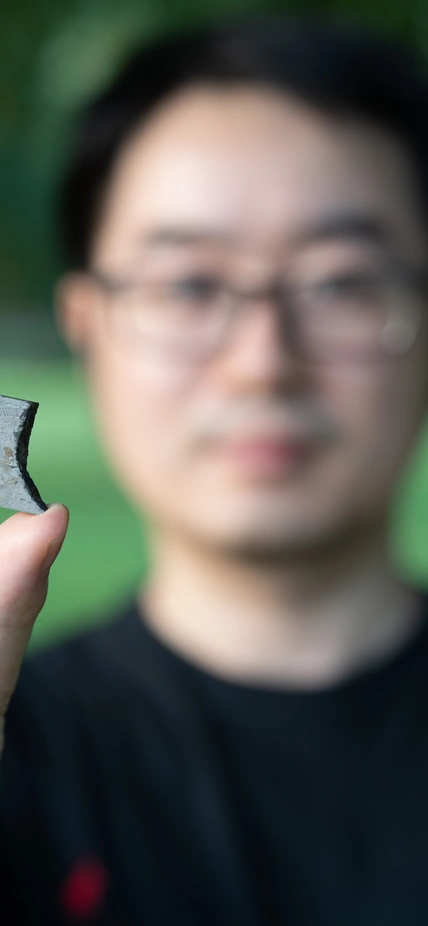 Peng Ni Hold Meteorite