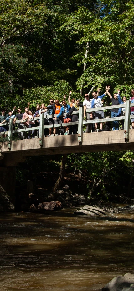 Postdocs and scientists cheer on Rapids Bridge in Rock Creek Park during Postdoc Appreciation Day