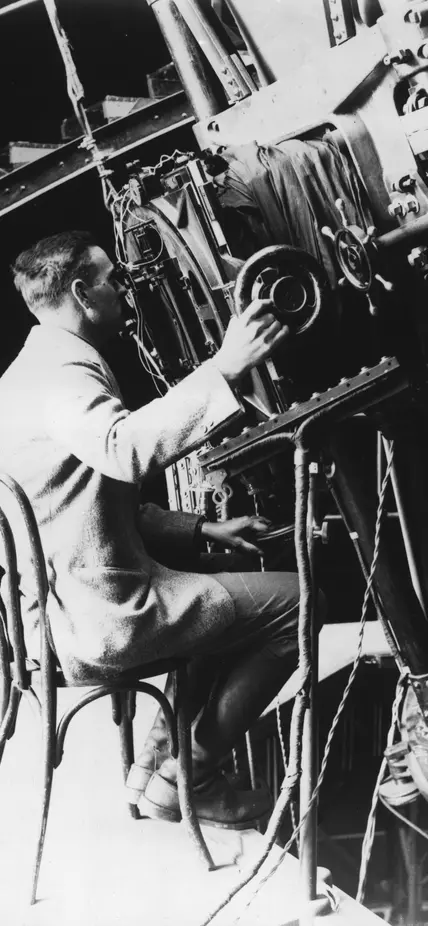 Edwin Powell Hubble seated at the 100-inch reflecting telescope, Mount Wilson Observatory.