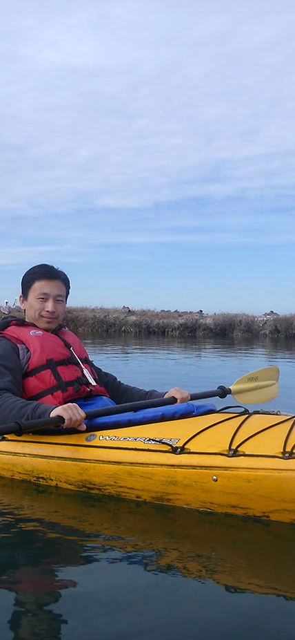 Ecologists kayak on a fieldwork trip