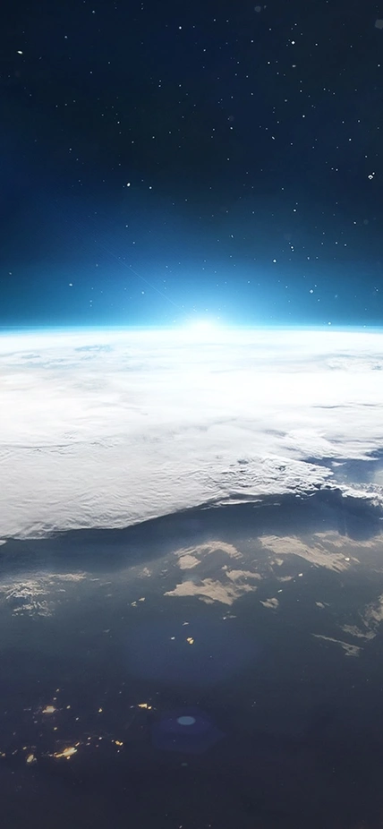 Earth seen from space with human settlements visible and the Moon in the background. Image purchased from Shutterstock.