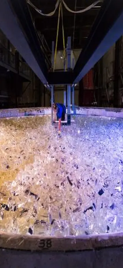 Mirror lab staff member places the last piece of glass into the mold for the fifth Giant Magellan Telescope mirror