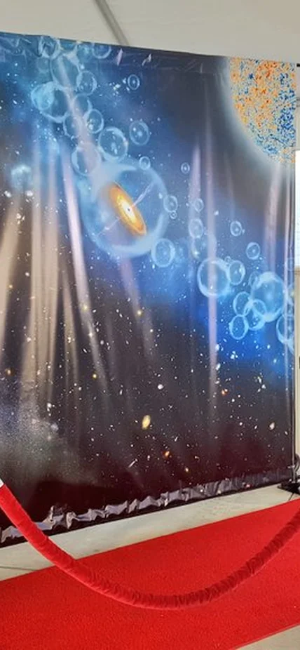 Attendees pose on the "red-shift carpet" at the Carnegie Observatories Open House. 