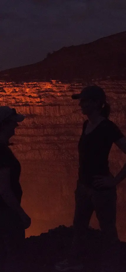 Lara and Diana Silhouetted against the glow of lava