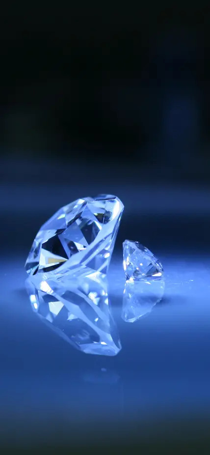 Cut and polished diamonds on a blue background
