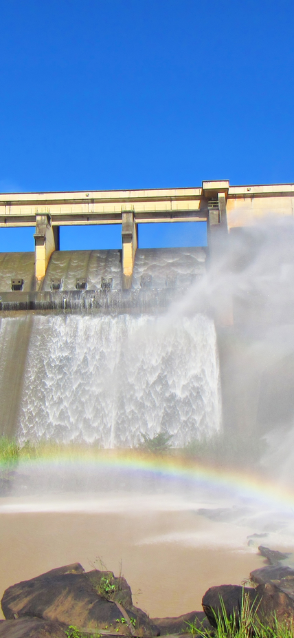 Rainbow in front of a dam wall. Shot in Hazelmere Dam Nature Reserve, near Durban, North Coast of Kwazulu-Natal, South Africa.