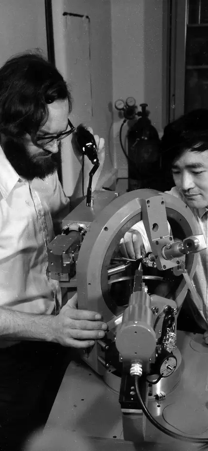 Larry Finger and Y. Ohashi aligning a crystal on the four-circle X-ray diffractometer in preparation for determining its structure