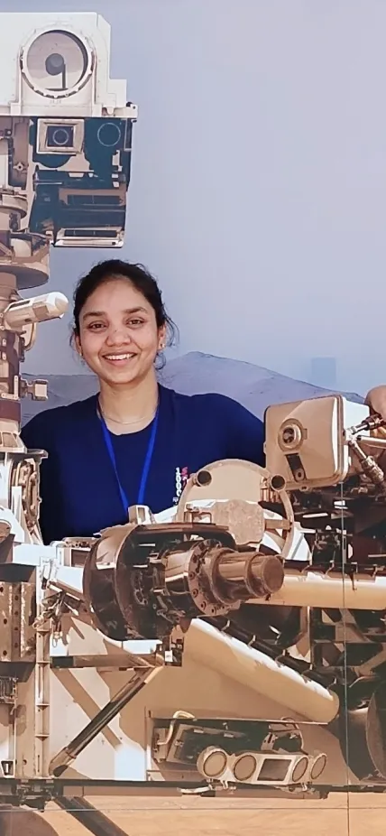 Anushree Srivastava poses with Mars rover mock ups