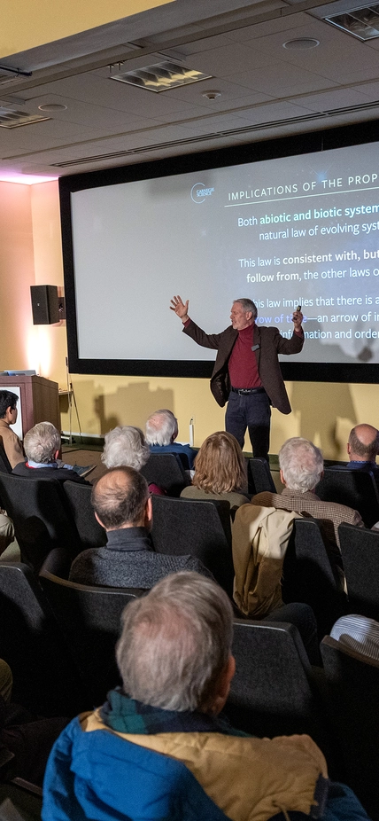 Bob Hazens tands infront of audience with arms outstretched