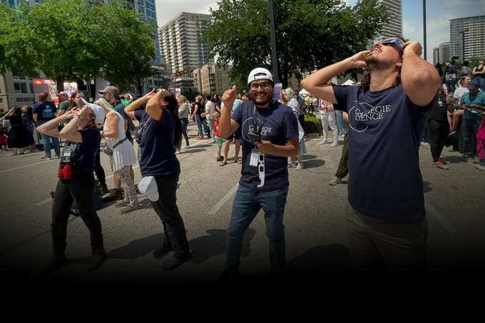 Carnegie Science volunteers look at the eclipse in Dallas Texas