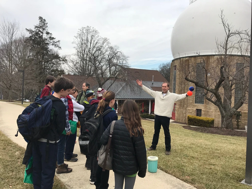 Conel Alexander demonstrates a science experiment for students from the Maret School