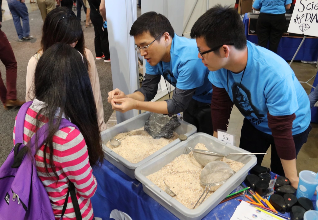 Attendees at the USA Science & Engineering Festival hunt for fossilized shark's teeth at the Carnegie booth