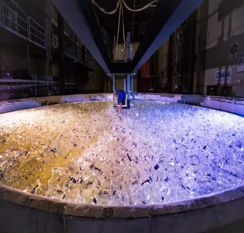 Mirror lab staff member places the last piece of glass into the mold for the fifth Giant Magellan Telescope mirror