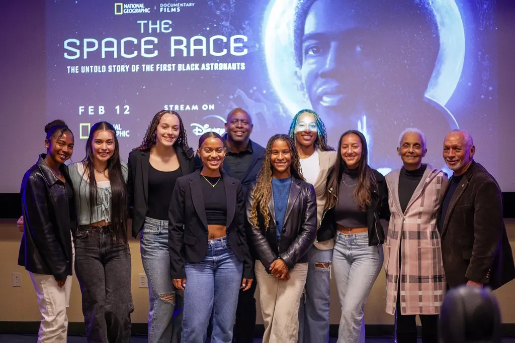 Members of the Howard University women's soccer team pose with former astronaut Leland Melvin and former NASA Administrator Charles Bolden