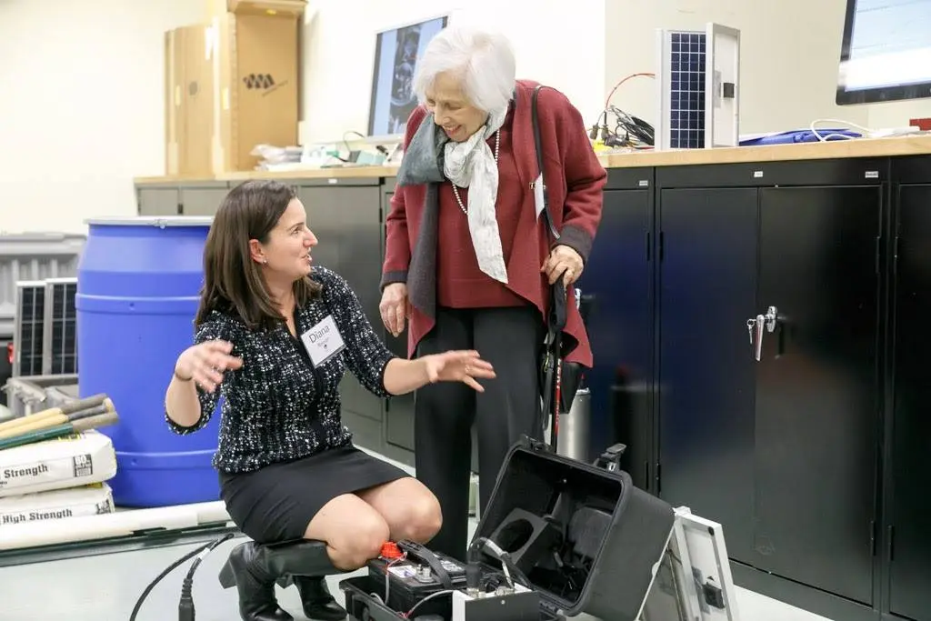 Maxine Singer learns about seismometers from Diana Roman