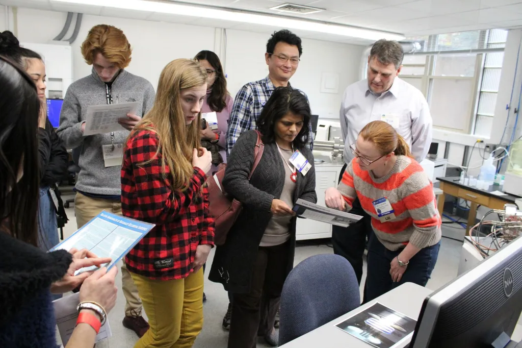 Timothy Mock gives a tour of the Mass Spectrometry lab to high school students from the 2019 American Junior Academy of Science conference.