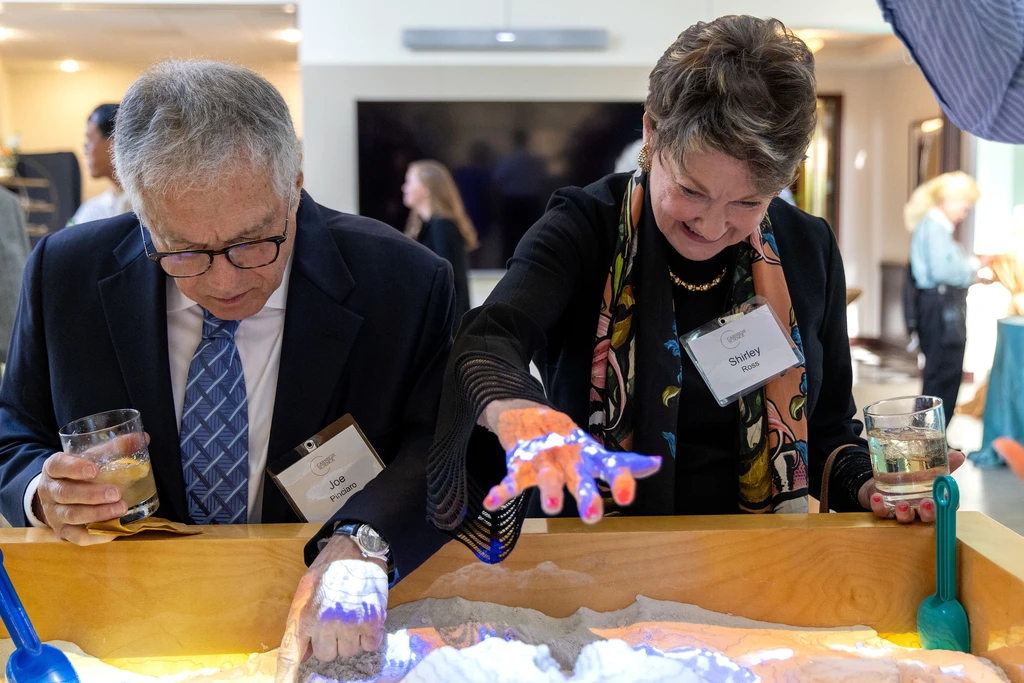 Explore the world through hands on stations like the topography sandbox.