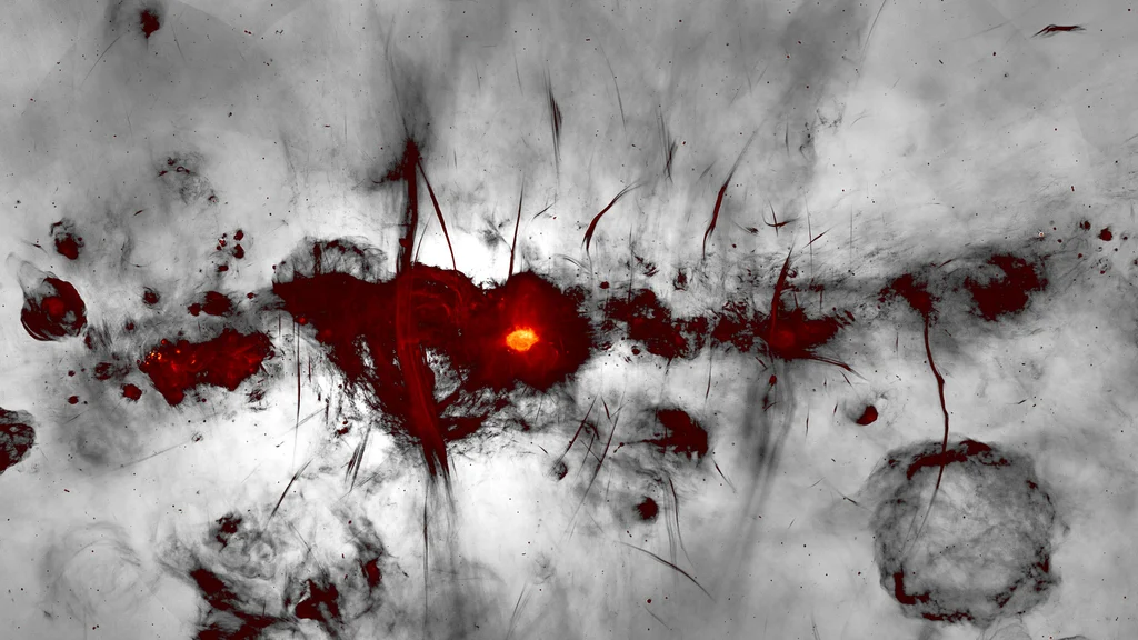 The MeerKAT image of the Galactic center region is shown with the galactic plane running horizontally across the image. 