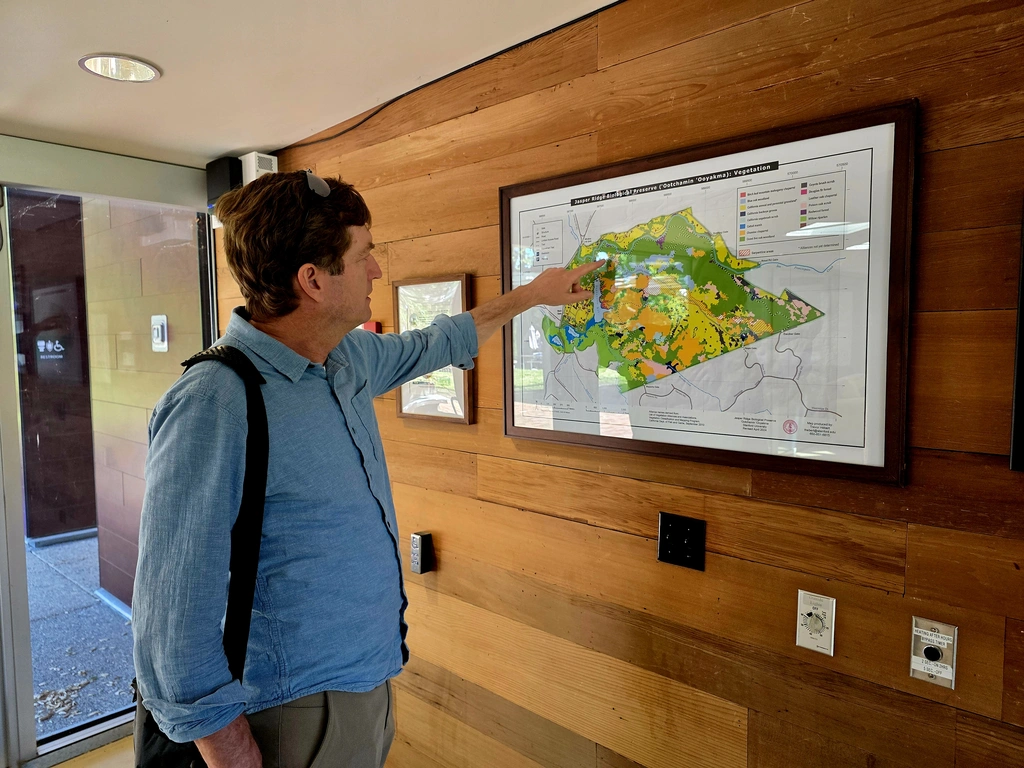 Jeffrey Dukes consults the map on the wall of the Jasper Ridge Biological Field Station