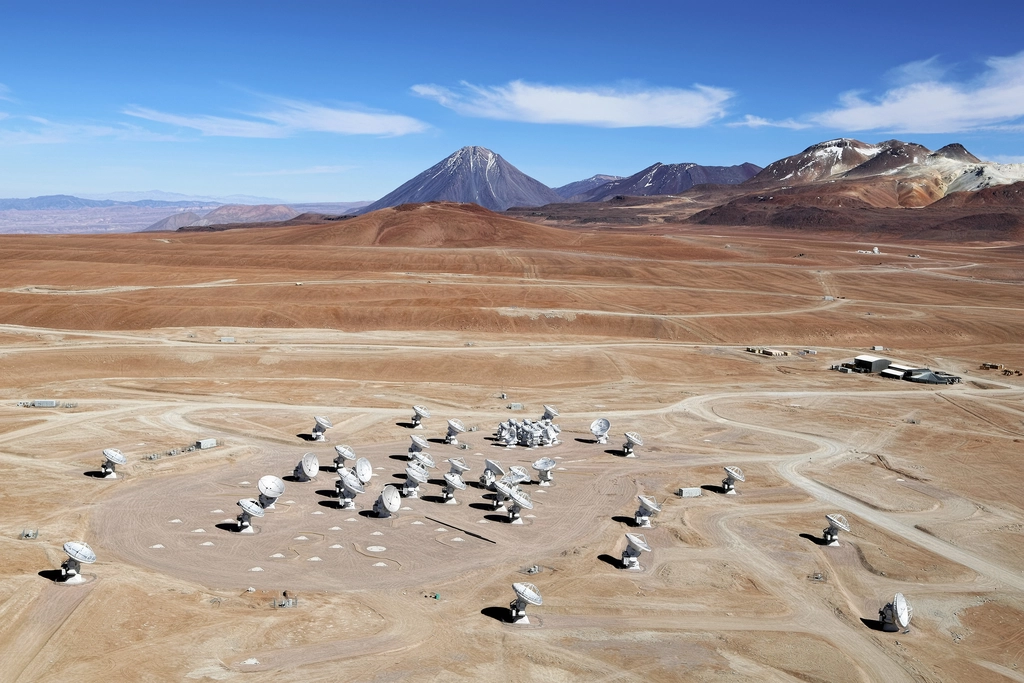 This image shows an aerial view of the Chajnantor Plateau, located at an altitude of 5000 meters in the Chilean Andes, where the array of ALMA antennas is located. 