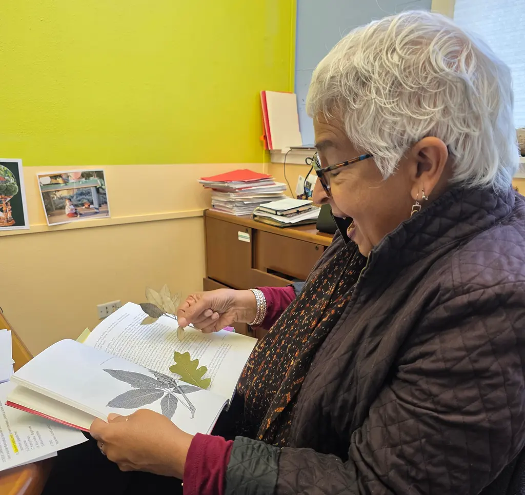 Devaki Bhaya looks at book from her Party With Trees class. Courtesy: Carnegie Science.