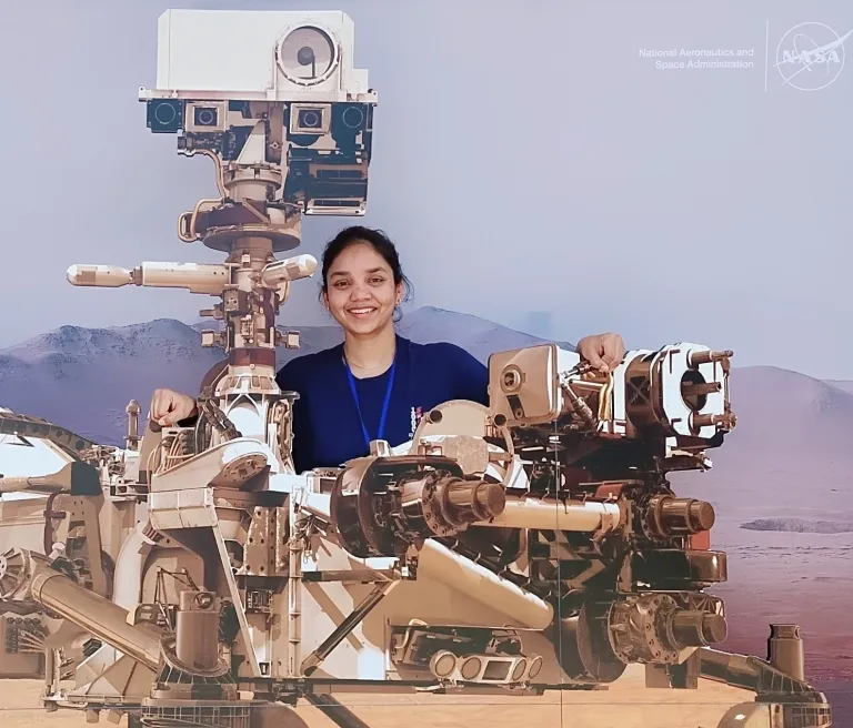 Anushree Srivastava poses with Mars rover mock ups