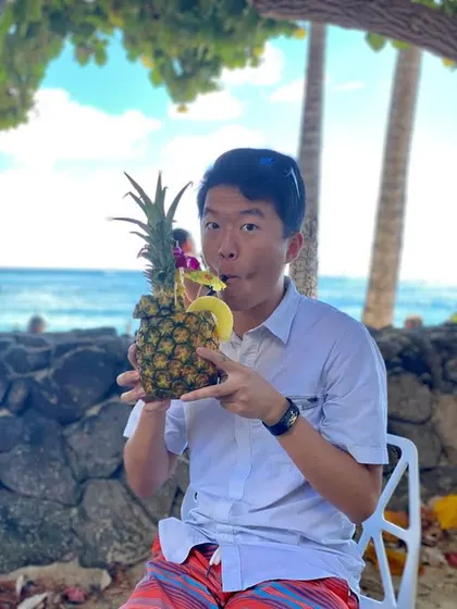 Guangwei poses with a pinapple