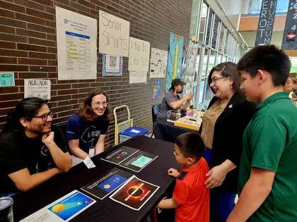 Two Carnegie Science astronomers table at a community event in Dallas