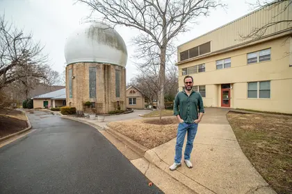 Oded Elazar stands outside on the Broad Branch Road campus