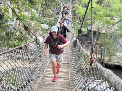 Casey Lam runs across a bridge during a Postdoc Appreciation Week trip to Disneyland 