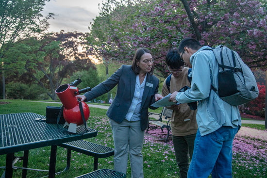 ALycia Weinberger uses a table top telescope