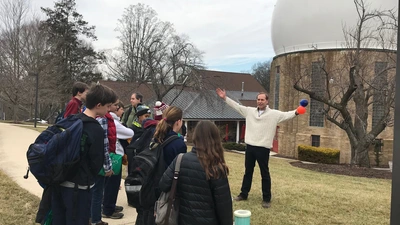 Conel Alexander demonstrates a science experiment for students from the Maret School