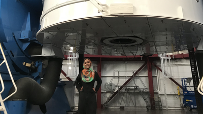 Munazza Alam stands in front of the Magellan Clay telescope at Carnegie's Las Campanas Observatory. Image courtesy Munazza Alam.