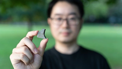 Peng Ni Hold Meteorite