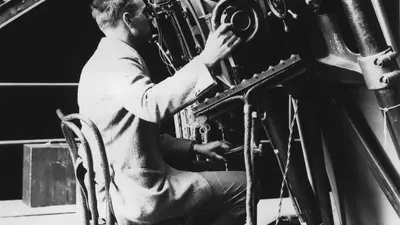 Edwin Powell Hubble seated at the 100-inch reflecting telescope, Mount Wilson Observatory.