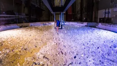 Mirror lab staff member places the last piece of glass into the mold for the fifth Giant Magellan Telescope mirror