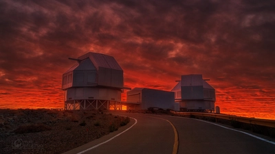 Sunset reddens the sky behind the Magellan telescopes at Carnegie's Las Campanas Observatory in Chile. 