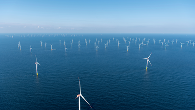 Offshore wind farm in blue water. 