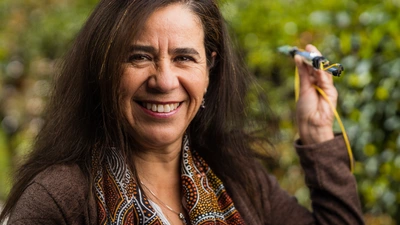 Solange Ramirez poses with an SDSS-V robot