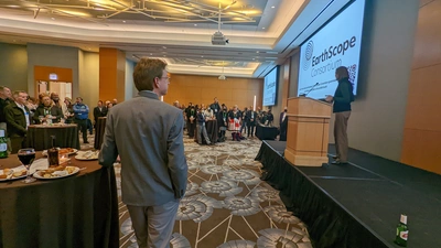 Lara Wagner stands at podium at EarthScope Reception