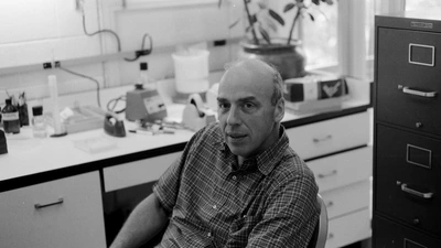 Donald Brown seated in the lab in Baltimore. Black and white photo. 