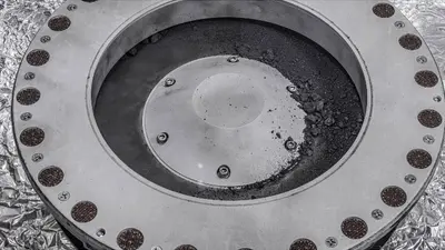A view of the outside of the OSIRIS-REx sample collector. Sample material from asteroid Bennu can be seen on the middle right. Scientists have found evidence of both carbon and water in initial analysis of this material. The bulk of the sample is located inside. Photo: NASA/Erika Blumenfeld & Joseph Aebersold